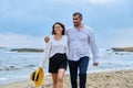 Happy mature couple walking on the beach Royalty Free Stock Photo