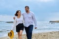 Happy mature couple walking on the beach Royalty Free Stock Photo