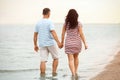 Happy mature couple walking  on sea beach Royalty Free Stock Photo