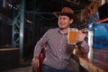 Cowboy drinking beer at the saloon