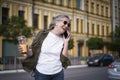 Happy mature European woman laughing talking on the phone enjoying free time after work or traveling having juice on the Royalty Free Stock Photo