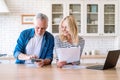 Happy mature family couple managing household budget together Royalty Free Stock Photo