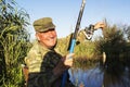 Happy mature fisherman with fresh caught crucian