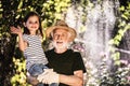 Happy mature gardener and his grandchild in parkland Royalty Free Stock Photo