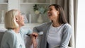 Happy mature grandmother and granddaughter chatting, laughing at joke Royalty Free Stock Photo