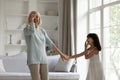 Happy grandmother and little granddaughter dancing and laughing together Royalty Free Stock Photo