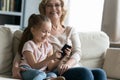 Happy mature grandmother and little granddaughter having fun with smartphone Royalty Free Stock Photo