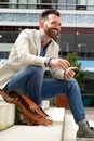 Happy mature guy sitting outdoors Royalty Free Stock Photo
