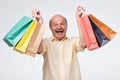 Happy mature hispanic holding paper bags with gifts after shopping. Royalty Free Stock Photo