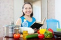 Happy mature housewife with book