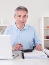 Happy Mature Man Calculating Royalty Free Stock Photo