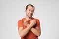 Happy mature man crossing his arms in front of the chest, showing his power and strength.