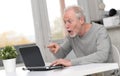 Happy mature man having a good surprise on laptop Royalty Free Stock Photo