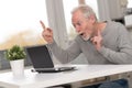 Happy mature man having a good surprise on laptop Royalty Free Stock Photo