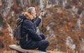 Mature man on a hiking resting on a bench and enjoy the view