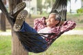 happy mature man laying on a hammock at resort garden on summertime Royalty Free Stock Photo