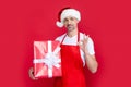 happy mature man in santa claus hat and red apron hold present Royalty Free Stock Photo