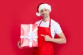 happy mature man in santa hat and red apron hold gift Royalty Free Stock Photo