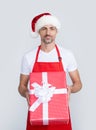 happy mature man in santa hat and red apron hold present Royalty Free Stock Photo