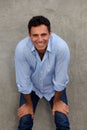 Happy mature man smiling with hands on knees Royalty Free Stock Photo