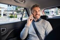 Happy mature man in taxi talking on phone Royalty Free Stock Photo