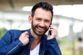 Happy mature man using mobile phone and smiling Royalty Free Stock Photo