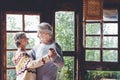 Happy mature man and woman dance at home enjoying love. Senior people relationship have fun indoor in active dancing leisure. Aged Royalty Free Stock Photo