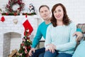 Happy mature,middle aged couple sitting on sofa at home. Christmas celebration, new year holidays Royalty Free Stock Photo