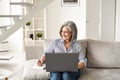 Happy mature old professional woman working on laptop from home office. Royalty Free Stock Photo