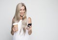 Happy mature old 60s woman with long hair holding smartphone Royalty Free Stock Photo