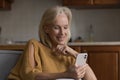Happy mature old smartphone user woman using Internet app Royalty Free Stock Photo