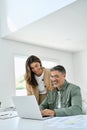 Happy mature older couple using laptop technology at home. Vertical candid shot. Royalty Free Stock Photo