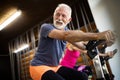 Happy senior people doing exercises in gym to stay fit