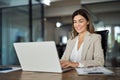 Happy mature professional business woman looking at laptop working in office. Royalty Free Stock Photo