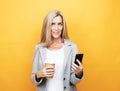 Happy mature senior woman with long hair holding smartphone using mobile online apps Royalty Free Stock Photo