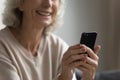 Happy mature senior woman using mobile applications. Royalty Free Stock Photo