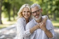 Happy Mature Spouses. Portrait of older couple hugging and smiling at camera Royalty Free Stock Photo