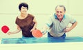 Happy mature spousesn playing table tennis Royalty Free Stock Photo