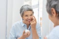 Senior woman applying anti aging cream Royalty Free Stock Photo