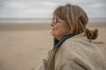 Happy Mature woman in the beach in winter