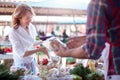 Happy mature woman buying fresh organic vegetables in a local marketplace Royalty Free Stock Photo