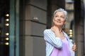 Happy mature woman on city street. Smart aging Royalty Free Stock Photo