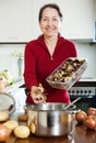 Happy mature woman cooking lent diet soup Royalty Free Stock Photo