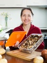 Happy mature woman with dried mushrooms Royalty Free Stock Photo