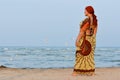 Happy mature woman enjoying breeze on seashore