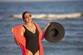 Happy mature woman enjoying on sea beach.