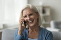 Happy mature woman enjoys mobile phone conversation Royalty Free Stock Photo