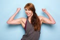 Happy mature woman flexing bicep muscles