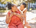 Happy mature woman and her adult daughter spending quality time together outside in the park during summer. Beautiful Royalty Free Stock Photo