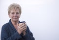 Happy mature woman holding a cup of coffee Royalty Free Stock Photo